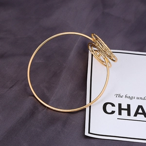 Minimalist gold leaf and spiral geometric upper arm cuff with intricate metal wire design