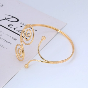 Adjustable golden double spiral arm cuff bracelet with elegant spherical bead accents