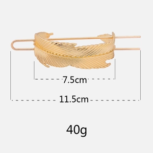 Golden feather hair pin accessory showing dimensions of 7.5cm width and 11.5cm length