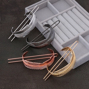 Detailed metal feather hairpins set in gold, silver, rose gold and gun grey finishes
