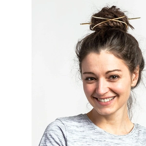 Minimalist polished golden metal hair sticks set shown in a stylish bun hairstyle