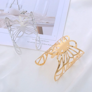 Minimalist open butterfly bangle set in gold and silver finish on white fabric
