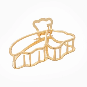 Elegant gold butterfly hair claw clip with wavy design and hollow metal frame for women