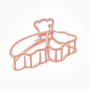 Detailed view of rose gold hollow butterfly hair claw clip with strong metal spring