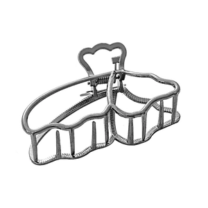 Detail of silver hollow butterfly claw clip with strong metal spring and polished finish
