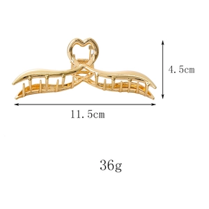 Dettaglio delle dimensioni di una molletta dorata da 11,5 cm con manico a cuore