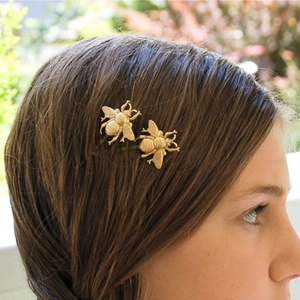 Set of 2 vintage golden bee hair clips shown on hair for a stylish fashion look