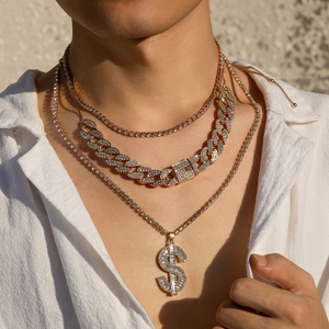 Close-up of triple layered gold hip hop necklaces with crystal dollar pendant and Cuban link