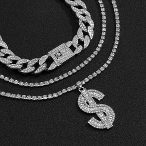 Macro shot of silver hip-hop Cuban link chain and tennis chain with $ sign pendant