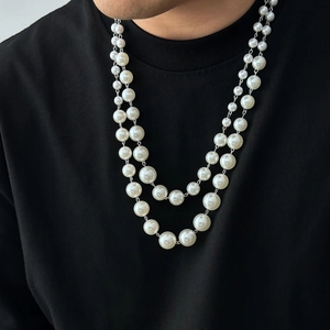 Men's double-layered pearl necklace with silver chain on black t-shirt streetwear style