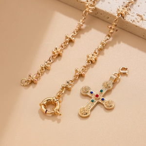 Detail of vintage gold-tone hip-hop necklace with multi-color crystal cross pendant