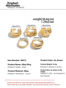 Detail of five-piece gold alloy ring set showing hammered texture and size measurements