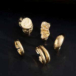 Detailed view of 5-piece gold-plated rings set featuring lava texture and irregular designs
