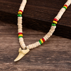 Close-up of surfer necklace with coconut shell beads and detailed shark tooth pendant
