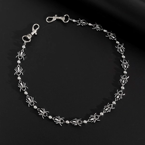 Macro shot of silver metal punk pants chain featuring detailed spider charms and lobster clasps
