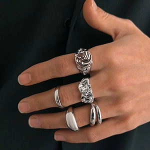 Five-piece silver liquid metal ring set with lava textures and minimalist polished bands