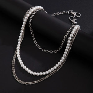 Close-up of triple-layer trouser chain with white pearls and silver-tone punk metal links