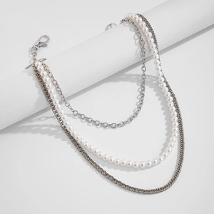 Detail of multi-layered hip-hop pants chain with silver metal links and white pearls