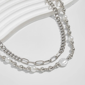 Detail of silver layered chain with white baroque pearls and metallic beads accessory