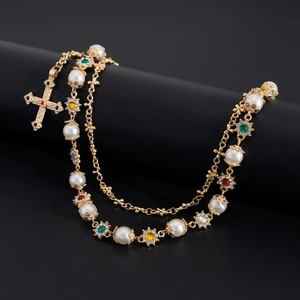 Detail of cross pendant on pearl waist chain with vintage colorful gemstones