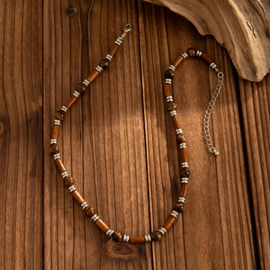 Ethnic beaded necklace featuring tiger eye stones, wooden beads and silver spacers