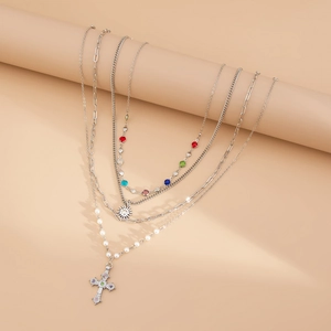 Dettaglio collana a strati argento con ciondolo sole, pietre colorate e perle finte