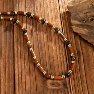 Detail of wooden beads and tiger eye stone beads on a vintage men's necklace chain