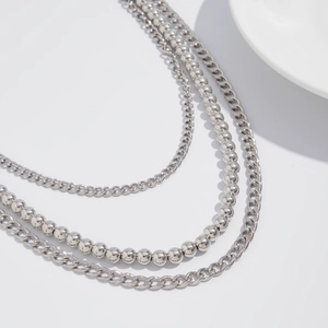 Close-up of triple-layered silver metal wallet chain with beads and Cuban links