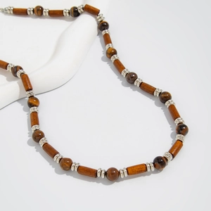 Ethnic style necklace with brown wooden cylinders, tiger eye beads and silver spacers