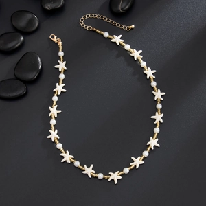 Detailed view of starfish pendant and faux pearls with adjustable gold lobster clasp