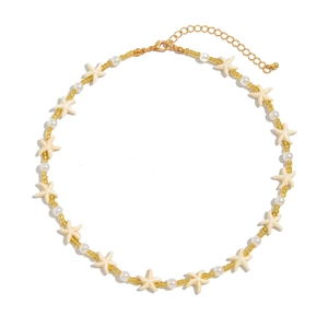 Bohemian style necklace with white starfish charms and elegant pearls for a coastal look