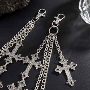 Close-up of vintage silver hip-hop punk waist chain with Gothic cross pendants