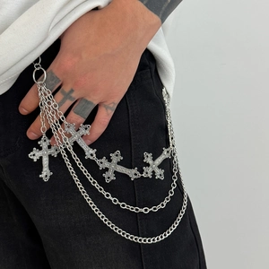 Detail of silver multi-layer hip-hop wallet chain with vintage cross pendants on jeans