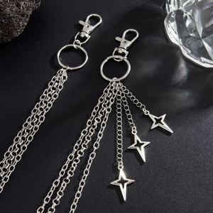 Close-up of Y2K style silver multilayered metal pants chain with hollow star pendants