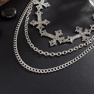 Detail of silver layered gothic hip hop chain with engraved metal crosses for jeans