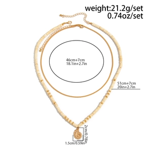 Detailed view of coconut shell bead necklace with shell pendant and size measurements