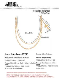 Detail of golden double-layered trousers chain with cross pendant and pearl accents