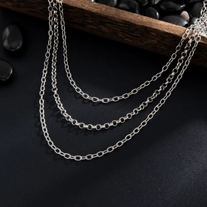 Detailed macro view of triple silver metal pants chains with various link styles