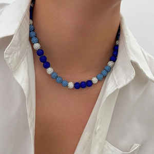 Detailed view of luxury multi-color beaded choker with crystals on male model neck