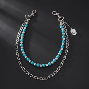 Detail of turquoise beaded waist chain with silver chain links and metal hat pendant accessory
