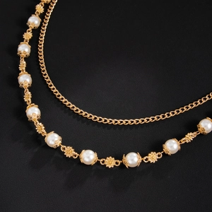 Close-up of double-layered hip-hop chain with white pearls and gold flower metal details