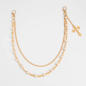 Close-up of double-layer gold chain with white pearls and a hollow cross pendant charm