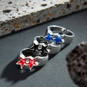 Close-up of three men's hip-hop star rings in red, black and blue enamel finishes