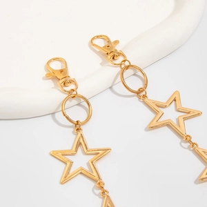Detailed close-up of golden hollow star charms with lobster clasp for hip-hop pants chain