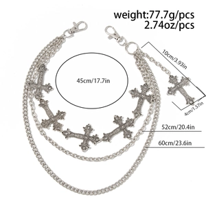 Detail of a triple-layer silver metal waist chain featuring ornate gothic cross pendants