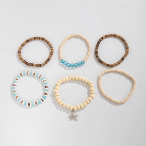 Flat lay of 6-piece bohemian beaded bracelet set with wood beads and starfish charm