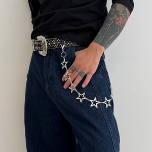Close-up of hip-hop silver metal star-shaped pant chain with lobster clasp on jeans
