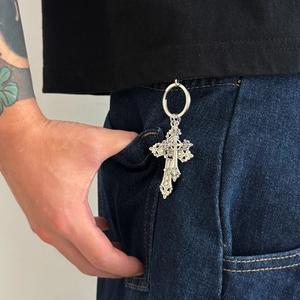 Hip hop vintage cross pendant keychain in silver finish hanging on blue denim jeans