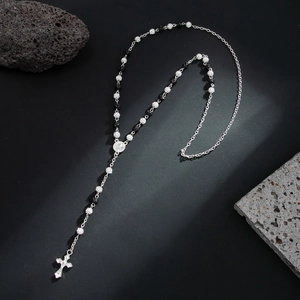 Hiphop rosary necklace with cross pendant and shiny silver beads on black background