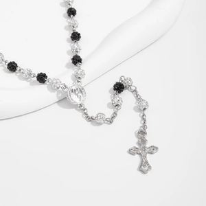 Detailed close-up of hip hop rosary necklace with silver crucifix and rhinestone beads